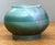 This captivating studio pottery vessel presents a sophisticated fusion of organic form and contemporary glaze work. Hand-...