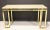 A beautifully crafted console table in solid brass with a floating travertine top, the Paul M. Jones piece available at...