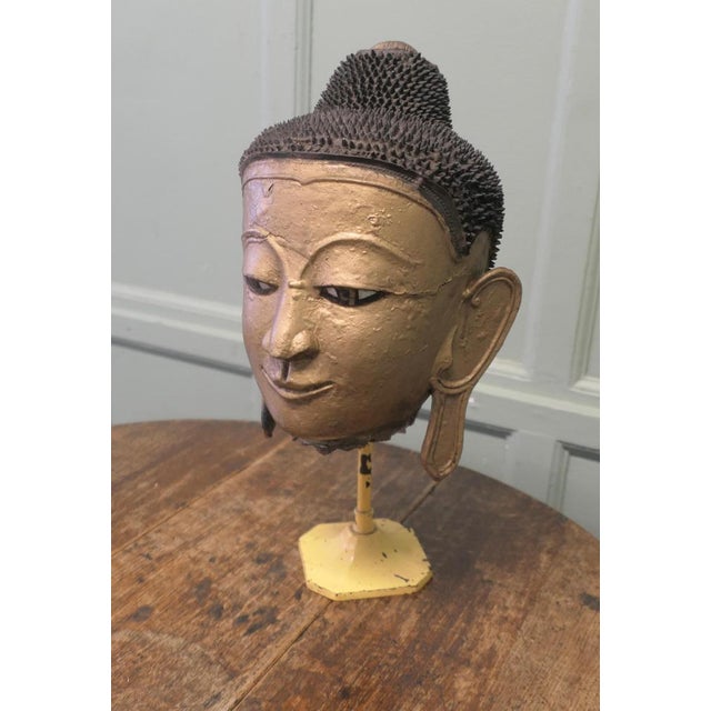 18th Century Burmese Buddha Head made in Gilt Dry Lacquer The Buddha head is made with the dry lacquer technique, the...