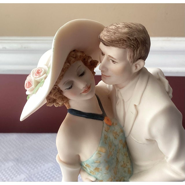 This romantic Giuseppe Armani figurine captures a tender moment between an elegantly dressed couple. The woman wears a...