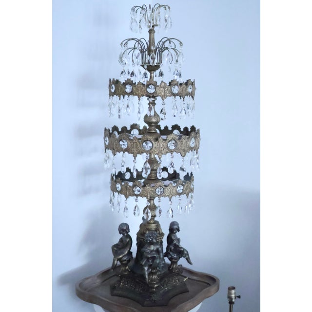 A spectacular, monumental 45-inch Hollywood Regency tiered waterfall table chandelier lamp. This striking statement piece...