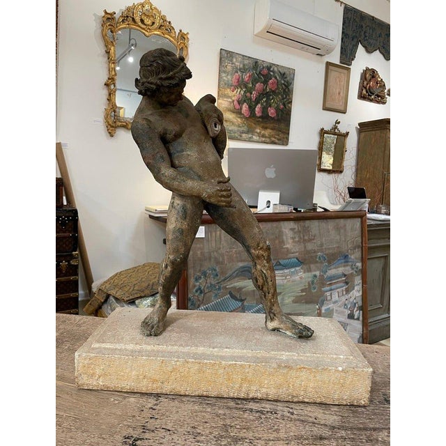 Bronze Grand Tour figure of a Satyr with a wine skin, originally part of a fountain, a finely modeled, mounted on a stone...