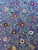 Hand-embroidered Suzani panel from Uzbekistan — red and cream floral rosettes on climbing vines over a cornflower blue...