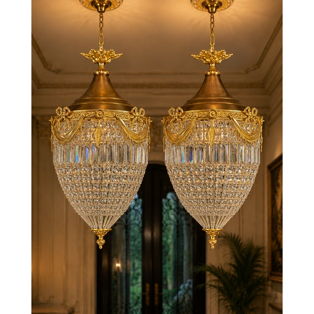 A refined pair of 1980 French Louis XVI–style bronze and crystal lantern chandeliers, made in Europe and finished in a...