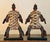 A striking matched pair of traditional African fertility dolls, carved in dark wood and densely sheathed in overlapping...