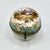 A rare antique porcelain hinged trinket box, hand painted with a romantic Watteau-style scene. This fine round box dates...