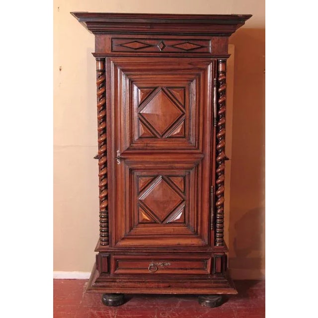 Tall, narrow, and architecturally striking, this antique French bonnetière was crafted in the Périgord region circa 1750....