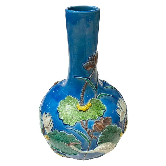 A rare Chinese stick vase depicting a serene egret feeding amid lotus pads and blossoms in a stylized water-lily pond — a...