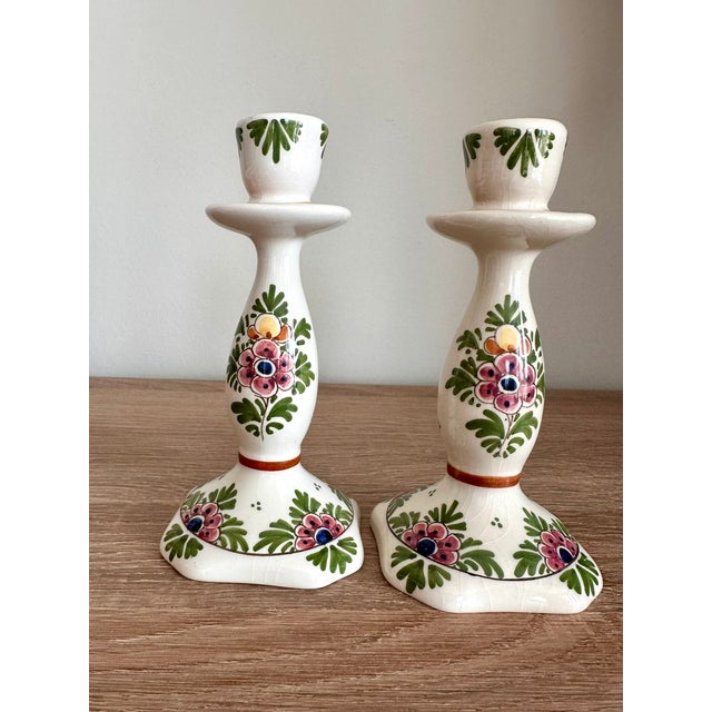 A charming matching pair of vintage Dutch Delft ceramic candlesticks attributed to De Candelaer (DC Delft), featuring...