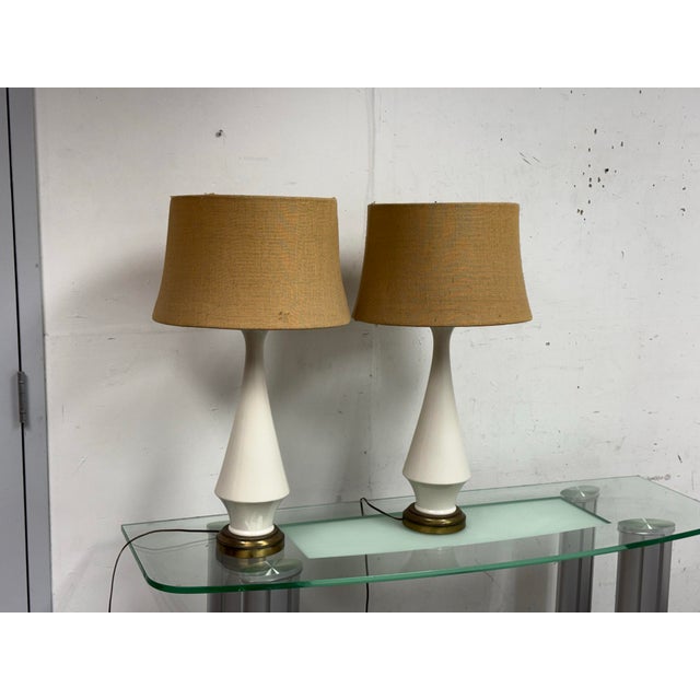Design Plus Gallery presents a Pair of Vintage Mid 20th Century Ceramic Table Lamps. They both have antique bronze bases...