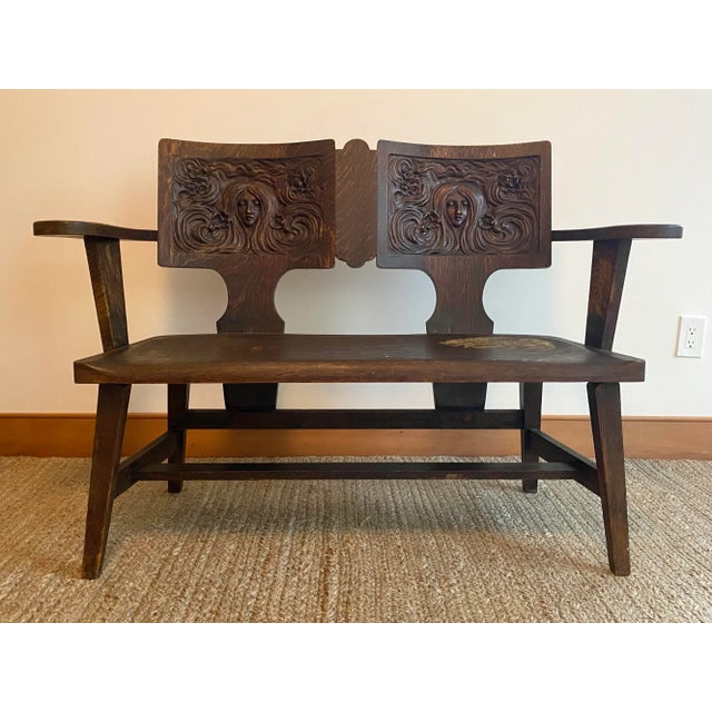 A rare, carved oak Symbolist bench by the George Arndt Chair Company. Art Nouveau design in American furniture is...
