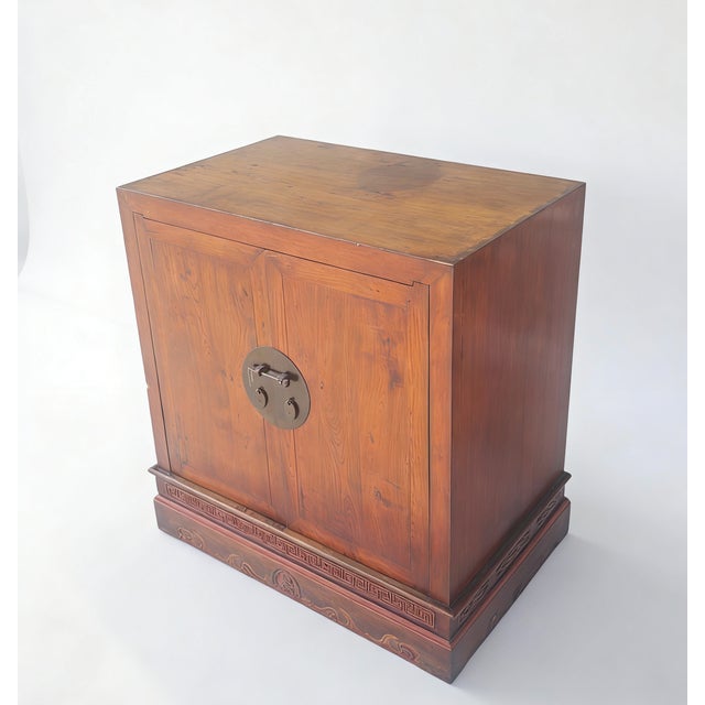Retrieved from Shanxi Province, this 19th century refined cabinet is crafted from solid elm wood. The rectangular body is...