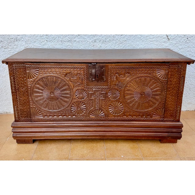 Beautiful antique Spanish wooden chest dating from the 19th century, featuring richly carved decorative panels inspired by...