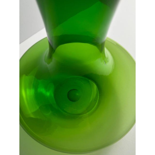 A large handblown green glass vase attributed to Reijmyre Glasbruk, Sweden, circa 1960s. Known for its vibrant coloration...