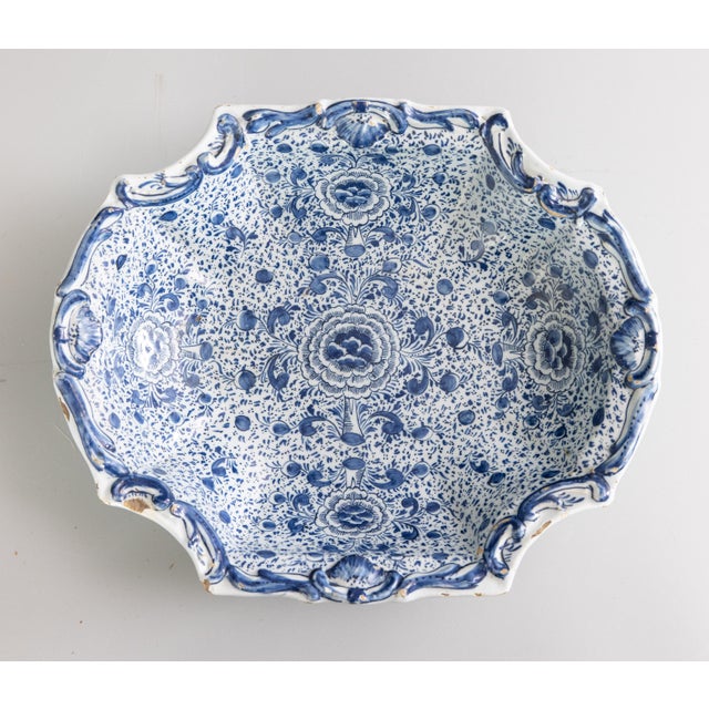 A beautiful rare 18th century four-lobed Delft dish, decorated in blue monochrome with flowers and semi-circles in...