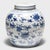This round, porcelain storage jar is brightly glazed in the classic blue-and-white manner with allover pattern of birds...