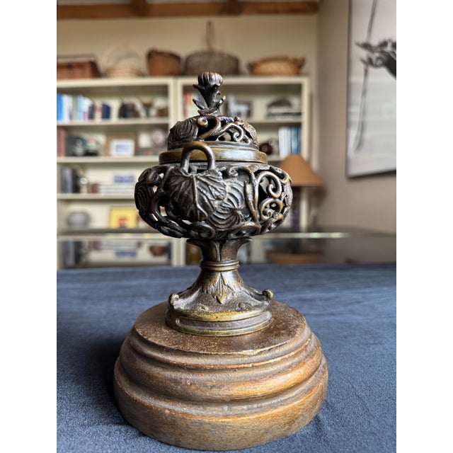 A small and beautifully cast Japanese bronze koro, or lidded incense burner, dating to the late Meiji or Taishō period,...
