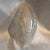 A 1930's era Art Deco clear and textured slip shade measuring 9.5" H x 5.25"W x 3"W at bottom. Fixture not included. No...