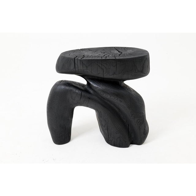 This unique side table or stool is a one-of-a-kind functional sculpture, carved from a single piece of wood to ensure its...