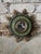 Quirky and unique green and metal industrial wall mirror. This small round mirror is filled with character, featuring...