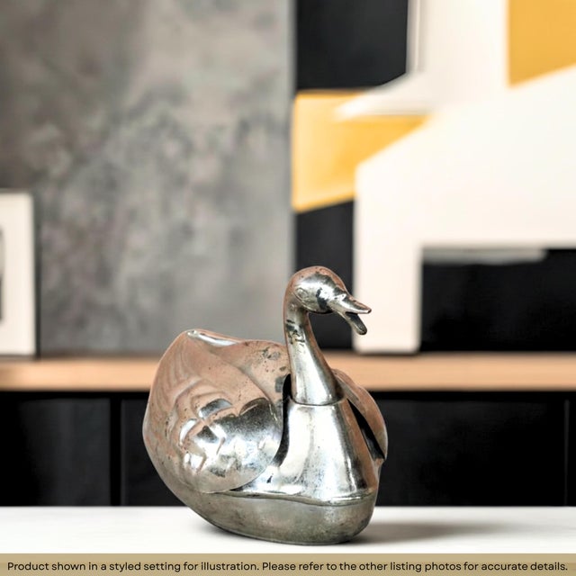 Dimensions: 9" W x 5" D x 7" H Looking for your next unique piece of home decor, this metal swan box might be just the...
