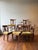 This set of eight 19th Century Neoclassical dining chairs features an upholstered seat cushion with a distinctive...
