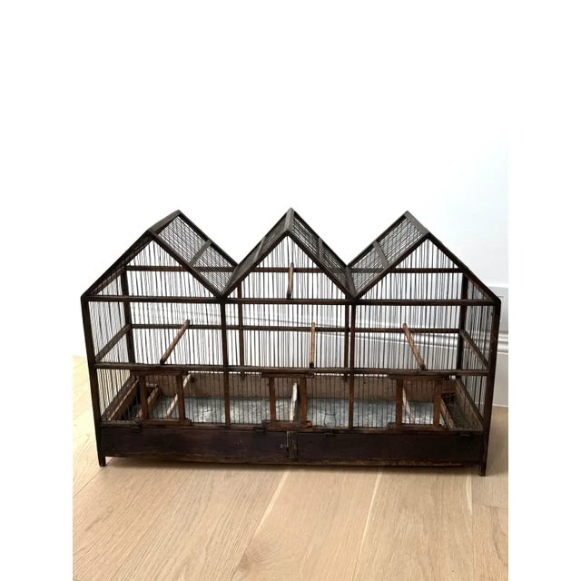 This is a large antique mid 19th century architectural model primitive birdcage. Perfect as sculptural piece in a Rose...