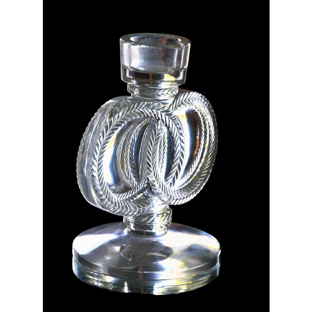Maison LALIQUE, based on a model created by Marc Lalique in 1945. Candlestick resting on a large circular base, made of...