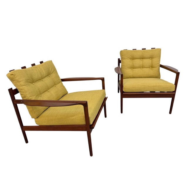 This rare pair of Mid-Century Danish Modern arm chairs was designed by Poul Jensen for Selig and showcases the sculptural...