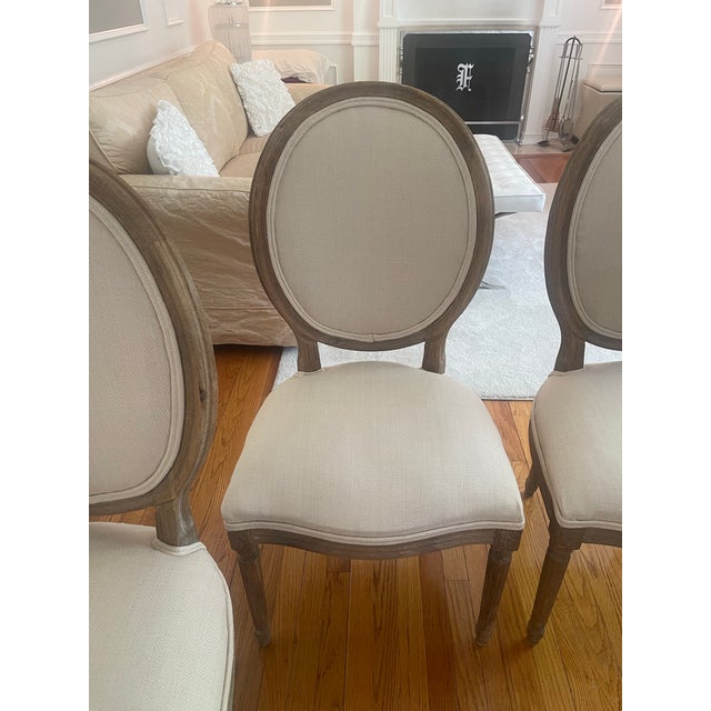 Set of 4 RH chairs. Washed oak weather finished and newly upholstered in Belgium linen. Chairs are in excellent condition...