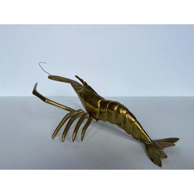 Mid century brass lobster sculpture from the 1960s. Perfect addition to a coffee table, desk or bookshelf or hand on the...