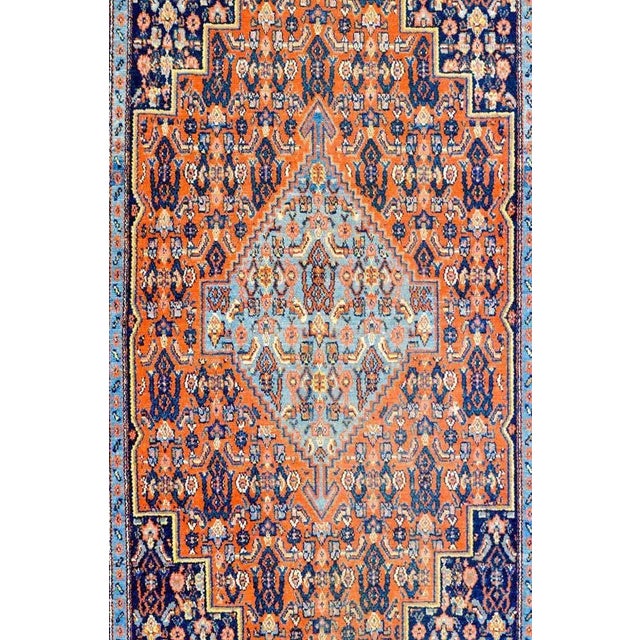A beautiful early 20th century Persian Seneh rug with a wonderful diamond medallion woven with an all-over multicolored...