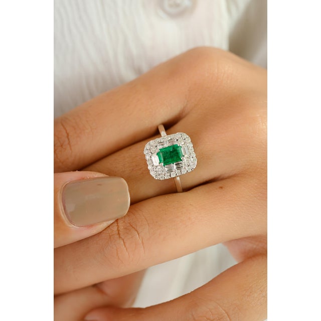 Exuding timeless elegance, this exquisite ring is crafted in 14k white gold and features a vibrant 0.52-carat emerald at...