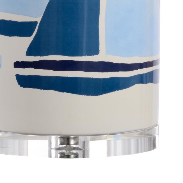 Ceramic lamp with hand painted sailboat designs in blue tones on an acrylic mount. Colors may vary. Designed by Jamie Merida.