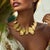 This Oscar de la Renta 22K gold-plated necklace features an intricate composition of interlocking ginkgo leaves hand-cast...