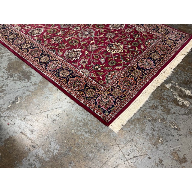 Design Plus Gallery presents a 5ft 10in × 8ft 10in Oriental Wool Area Rug. The rug showcases a red field adorned with an...