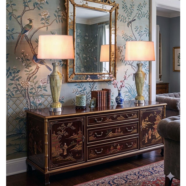 Offering a large and sophisticated pair of hand painted sage green and bronze colored ceramic table lamps with large...