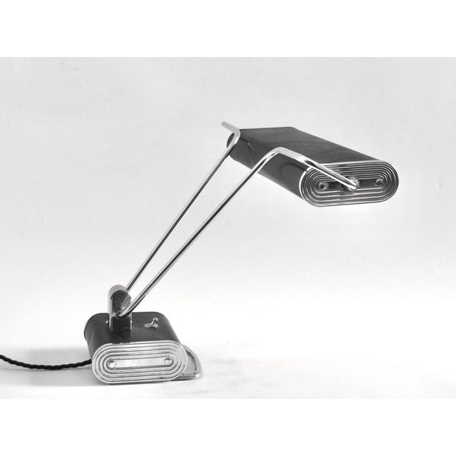 This Art Deco lamp was designed between 1920 and 1949 by Eileen Gray and produced by Jumo in France. It is made from...