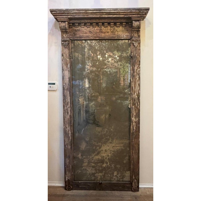A truly exceptional and one-of-a-kind monumental architectural pier mirror, salvaged from a 19th-century door surround and...