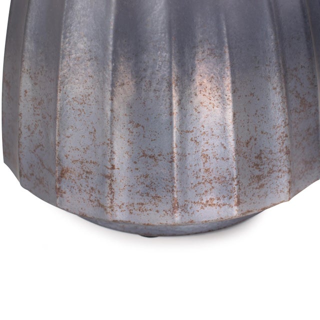 A stunning hand-blown glass piece featuring a sleek, ribbed design and a graceful ombre finish. The vase transitions from...