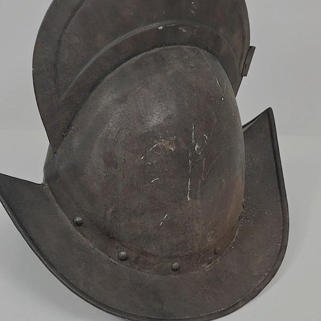 Circa 17th Century Spanish or German Comb Morion Helmet. The two-piece steel helmet is traditional infantry form, with...