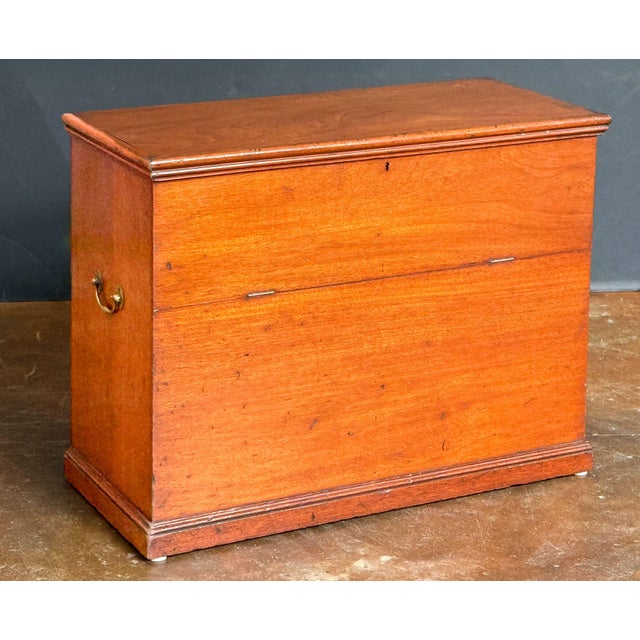 A fine English folding front chest or box of mahogany from the Edwardian era, featuring a hinged top over a fold-down...