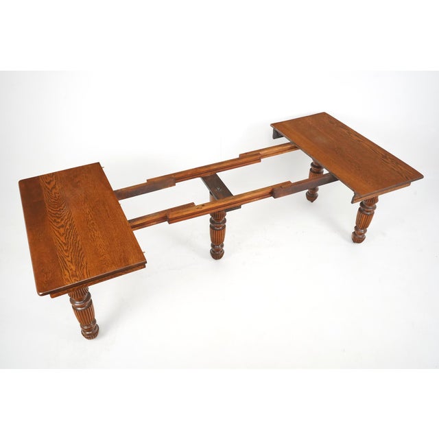 Antique Victorian style dining table made of solid oak with five leaves giving versatility in the desired length. The...
