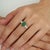 This Modern Mid-Century Style 2.54 Ct Oval Emerald & Marquise Diamond Ring features a striking combination of natural...
