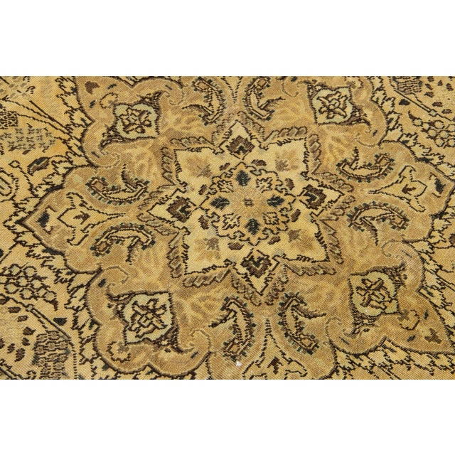 Beautiful antique Persian Tabriz hand-knotted wool rug with an ivory field. This piece has a tan frame and brown accents...