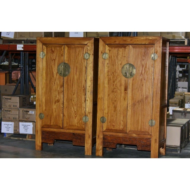 A pair of tall 19th century Chinese cabinets or armoires made with Ming Dynasty simplicity. This fantastic pair of...