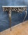 Exceptional neoclassical style console table crafted in gilt bronze with a marble top, dating to the mid-20th century. The...