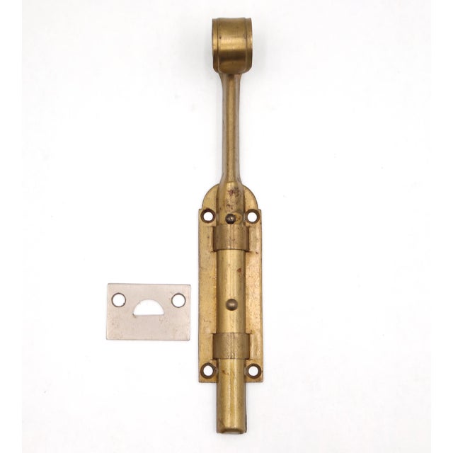 Vintage surface mount slide door bolt made of steel with a brass finish. The catch is made of brass with a nickel finish....