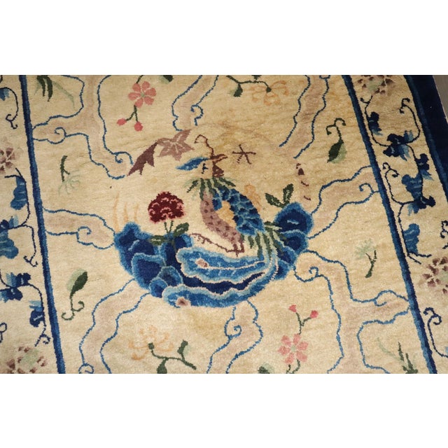 An early 20th-century pretty floral Chinese rug in beige and Blue