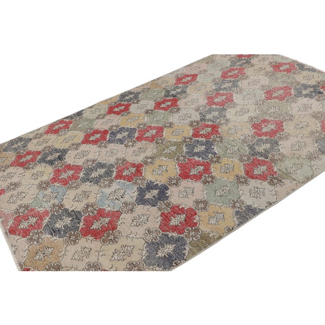 Handknotted in wool, this 5x9 vintage rug originates from Turkey, circa 1960-1970 and is believed to hail from the Turkish...